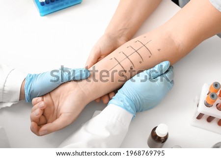 Young woman undergoing procedure of allergen skin tests in clinic Royalty-Free Stock Photo #1968769795