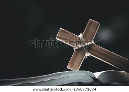 Closeup of  wooden christian cross  on Bible,  god, Wooden cross of Jesus. Royalty-Free Stock Photo #1968771874
