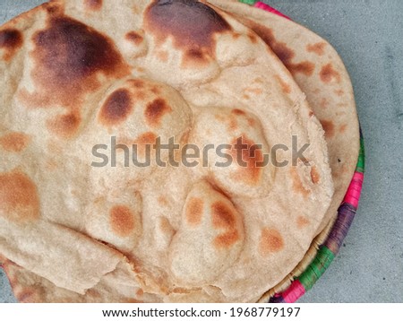 Flatbread (Roti). Roti is a round flatbread. Made from whole wheat flour dough. Bread is baked in the oven by kneading flour. Salted bread. Horizontal, landscape image. Close-up picture