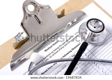 A doctor or nurses clipboard with a stethoscope and writing pen and a medical questionairre