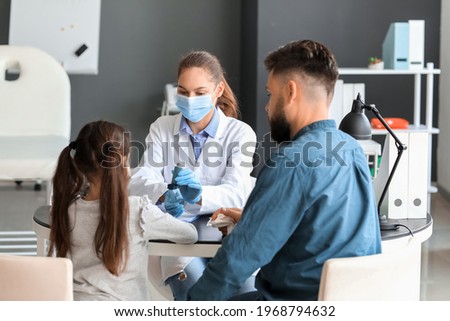 Little girl and her father visiting allergist in clinic Royalty-Free Stock Photo #1968794632