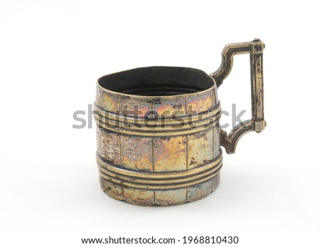 Old copper cup on a white background