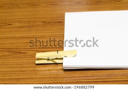 wooden pin paper on wood background