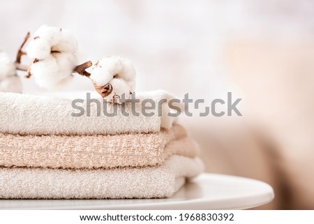 Cotton towels on table in bathroom Royalty-Free Stock Photo #1968830392