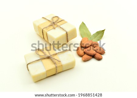 Almond milk soaps decorated with almond kernels, isolated on white background