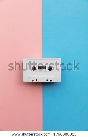 vintage white cassette tape on a blue and pink background