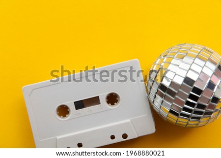 Retro disco glitter ball with a vintage cassette tape