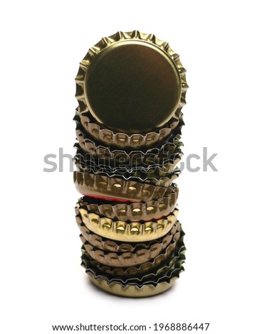Metal beer bottle caps pile isolated on white background