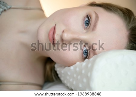 Portrait of a calm young woman with blue eyes.