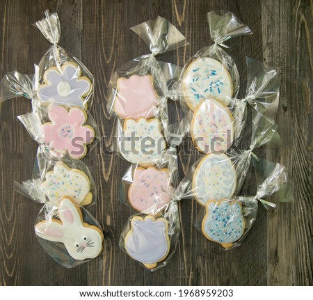 Easter sugar cookies with royal icing individually wrapped in clear bags.