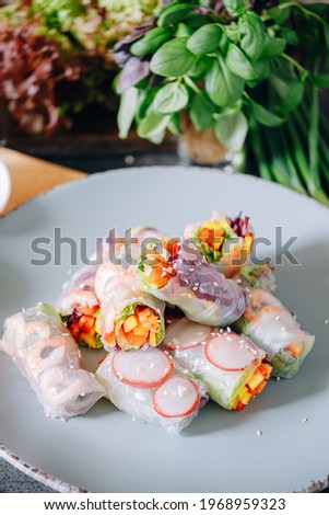 fresh springrolls with vegetables and shrimps. a healthy dish of rice paper and fresh organic vegetables Royalty-Free Stock Photo #1968959323