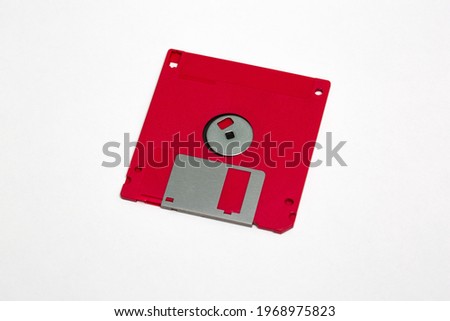 Red floppy disk stock photo isolated on white background.