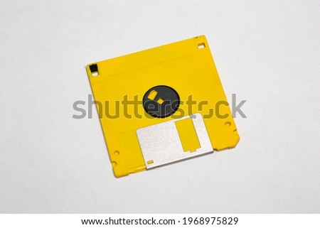 Yellow floppy disk stock photo isolated on white background.
