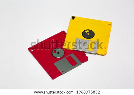 Red and yellow floppy disk stock photo isolated on white background.