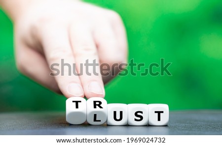 Dice form the words "Lust" and "Trust". Royalty-Free Stock Photo #1969024732