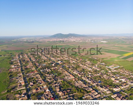 The settlement of Pavliš and behind the town of Vršac with a hill. Aerial photography. 