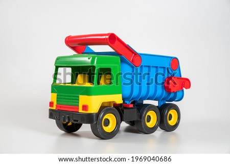 Multi-colored plastic children's toy cars on a white background. Truck.