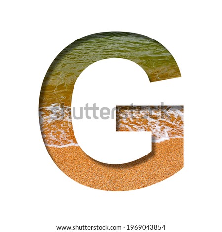 Sea shore font. The letter G cut out of paper on a background of the beach of seashore with coarse sand and emerald water. Set of decorative natural fonts.