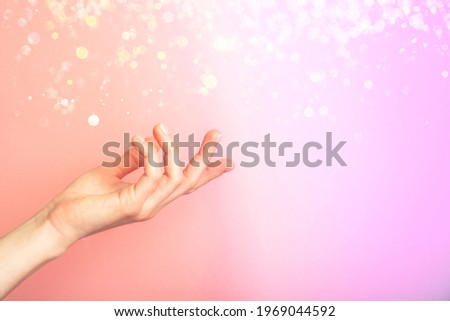 Beautiful female hand isolated on multicolored neon background with blur. Palm up, close up. High resolution product