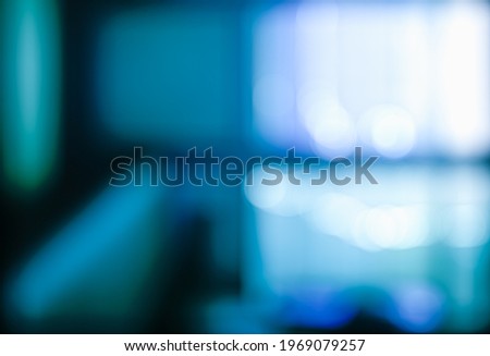 DARK BLURRED OFFICE BACKGROUND, NIGHT STUDIO NEWS ROOM INTERIOR WITH LIGHT REFLECTIONS AND BOKEH