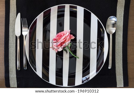 Pink Rose flower on Plate background Hipster Valentine dinner concept Royalty-Free Stock Photo #196910312