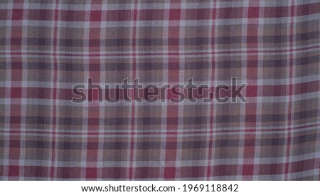 Checkered fabric with colored threads. Fabric for plaid coat and suit. Close-up. Background