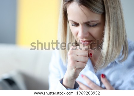Portrait of woman who is coughing closeup Royalty-Free Stock Photo #1969203952