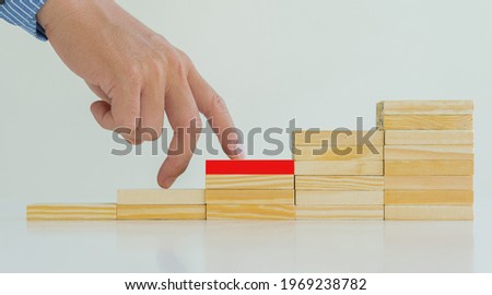 Business Risk Businessman defends the wood block on the table, planning and strategy in alternative business risks