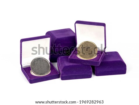 Gold coin , Silver coin
On Purple gift box isolated on white background.