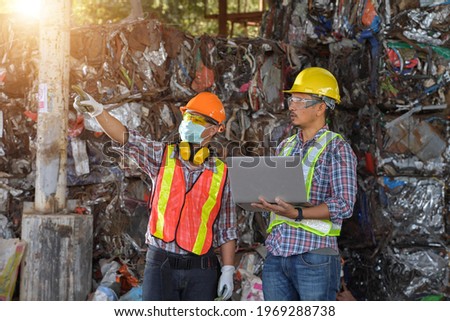 Recycling industry a worker who recycling thing on recycle center.Manager and Manual Worker in Metal Landfill