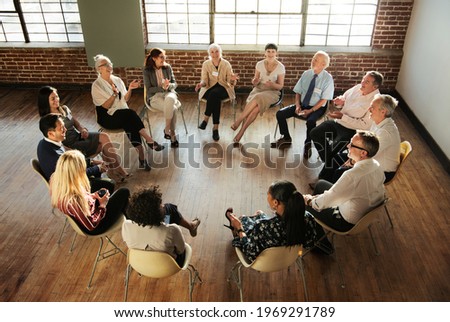 People sitting and talking with a group