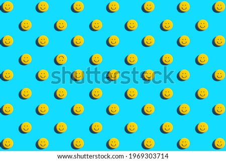 Yellow smiley face cookie, food, flat lay, top view, copy space on blue background. Be different. Royalty-Free Stock Photo #1969303714