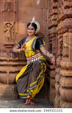 Portrait of beautiful Indian classical dancer with traditional costume posing in front of Mukteshvara Temple,Bhubaneswar, Odisha, India.Indian classical dance Odissi.