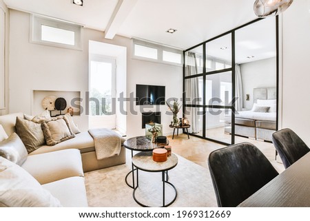 Modern flat with spacious bedroom and cozy living room designed in minimal style Royalty-Free Stock Photo #1969312669