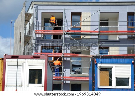 Workers building the building, workers' housing containers on the construction site Royalty-Free Stock Photo #1969314049