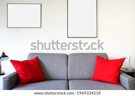 Blank picture frame on a sofa. Minimalist interior background