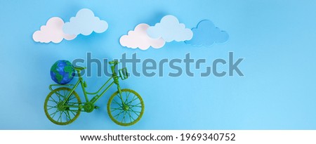 3rd June World Bicycle Day. Green bicycle on blue background. Environment preserve.