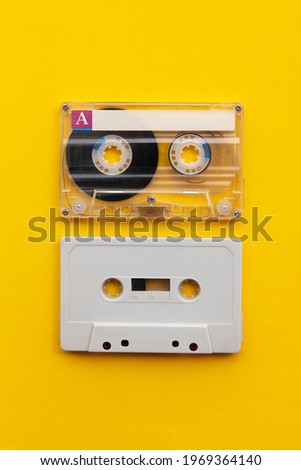 vintage white cassette tape on a bright yellow background