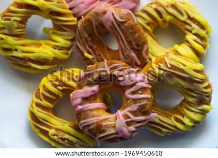 Donuts from San Isidro covered with yellow and pink sugar. Typical donuts from the San Isidro festival in Madrid as dessert