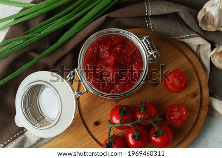 Jar with tomato paste and ingredients, top view