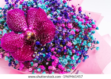 Beautiful bright bouquet with orchid on a light background.