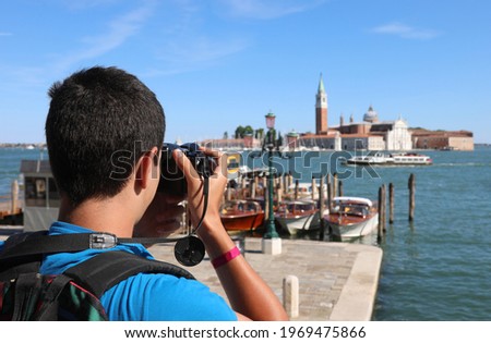 young photographer Take a picture at the church of Saint George in the Venice lagoon