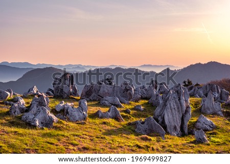 Landscape of Many Rocks and Stones on The Grassy Field under The Blue Sky in The Morning, Shikoku Karst in Japan, Natural or Environmental Image, Nobody Royalty-Free Stock Photo #1969499827