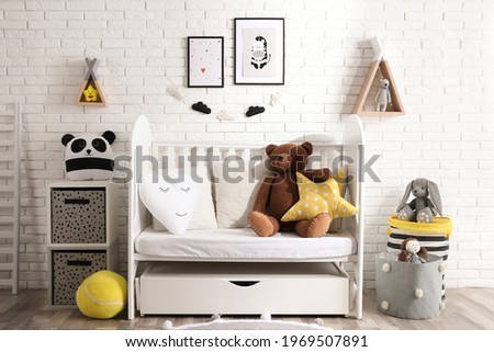 Cozy room with stylish furniture and toys for baby. Interior design