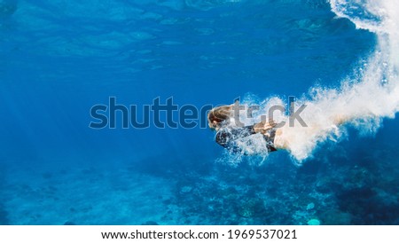 Happy family - active teenage girl jump and dive underwater in tropical coral reef pool. Travel lifestyle, water sport, snorkeling adventure. Swimming lessons on summer sea beach vacation with kids Royalty-Free Stock Photo #1969537021