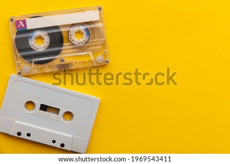 vintage white cassette tape on a bright yellow background