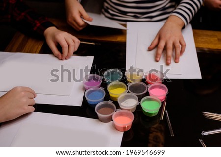 A child draws with colored sand picture. 