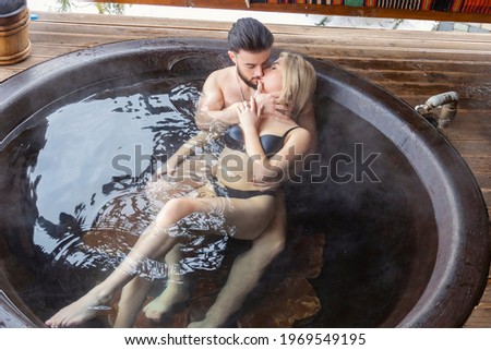 beautiful couple bathing in a vat