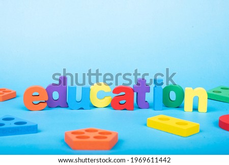Education word written with wooden alphabets blocks on blue chart kids children photo