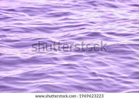 Texture of glitter water and soft waves. sparkling in water - background. sea water with sun glare and ripple. Powerful and peaceful nature concept.
